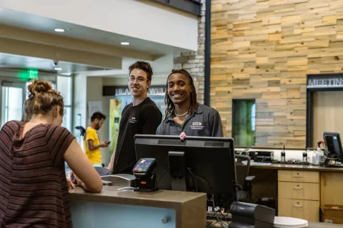 student employees working at the Rec Center's front desk