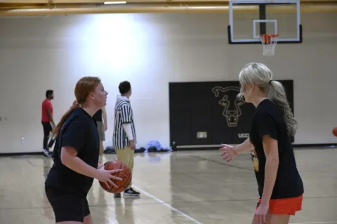 students playing basketball in the rec center