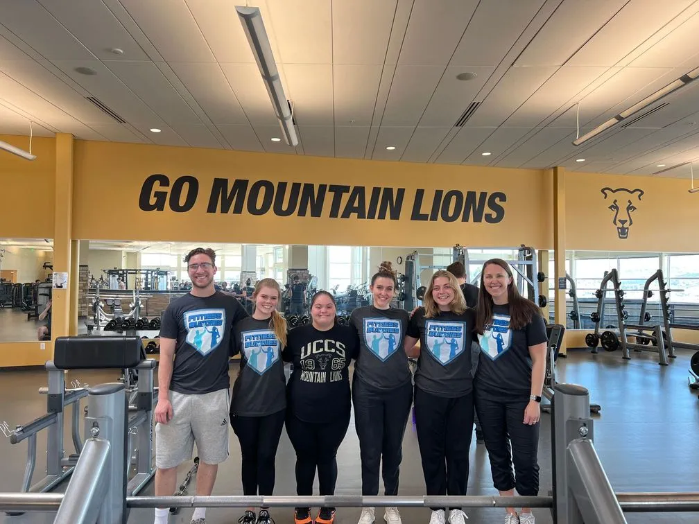 Fitness buddies standing together at the UCCS gym