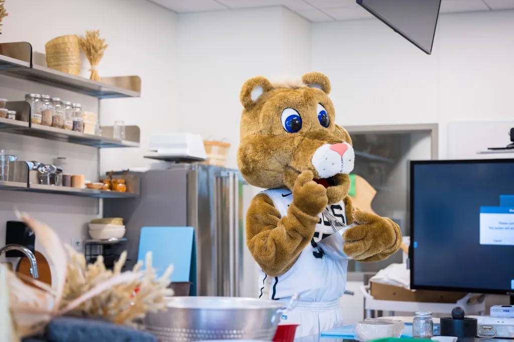 UCCS Mascot, Clyde, cooking in the Nutrition Kitchen