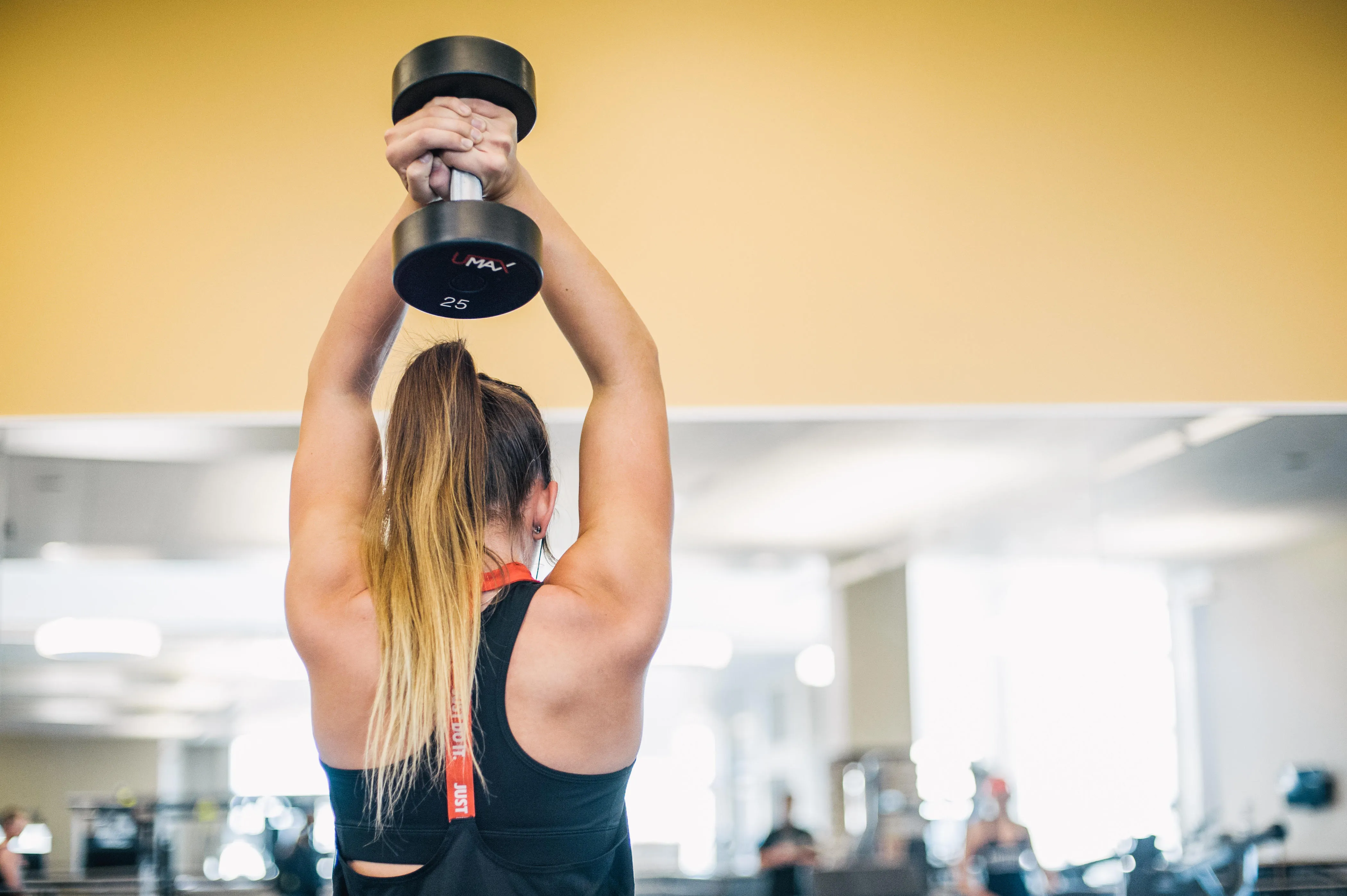 student working out with weights in the rec center